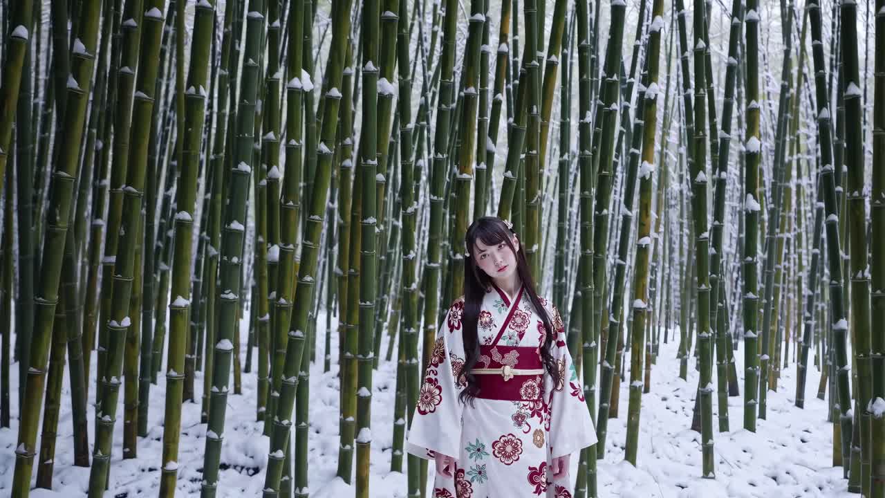 A serene video still of a woman in a floral kimono, looking down