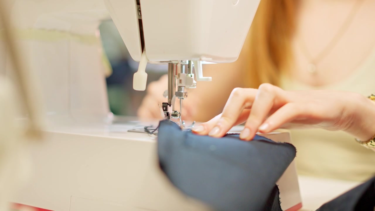 Seamstress using a sewing machine in a workshop