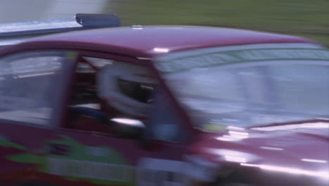 a race car travels around the track as people watch