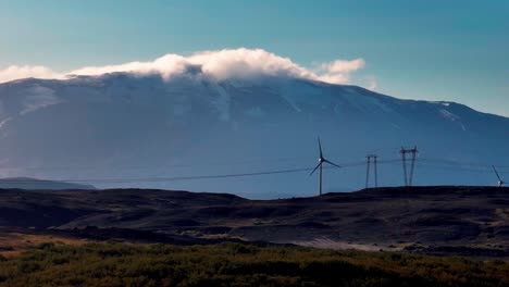 wind turbines with hekla volcano in the background in south iceland. - wide shot