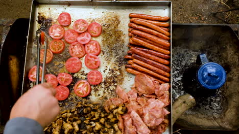 tongs used to flip tomatoes on big stainless steel pan - making brunch