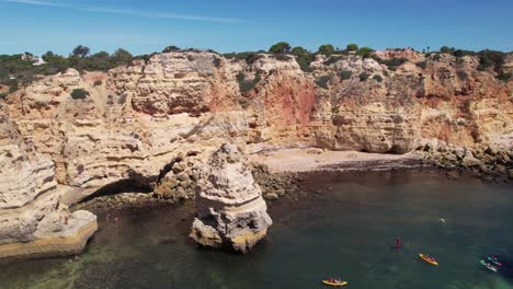 Flying-over-Praia-Da-Marinha--in-Algarve,-Portugal