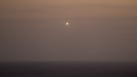 airplane flies over the sea