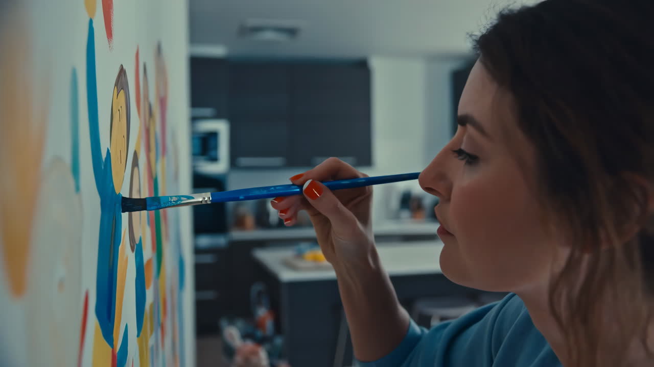 A woman paints artwork