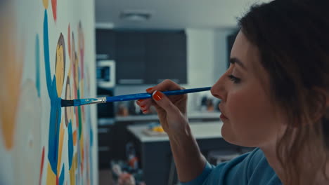 a woman paints artwork