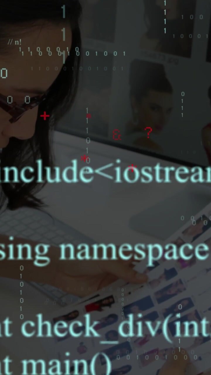 Vertical video: Woman reviewing headshots, touching monitor and summoning binary overlays for tech
