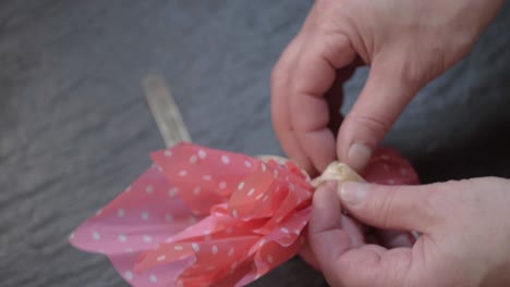 wrapping a gift with a ribbon bow