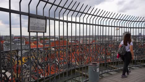 Woman-walking-along-the-circular-Rundetaarn-admiring-the-views-of-Copenhagen,-Denmark