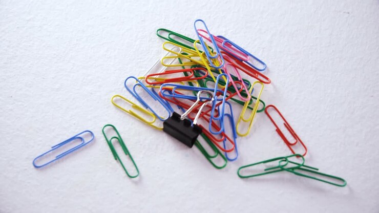Various paper clips on white background 4k