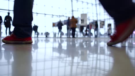 people walk inside a bright, modern building