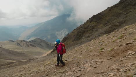 tourist backpacker hiking in high atlas mountains, morocco, tracking