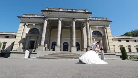 elegant wedding couple near the old building. young wedding couple are walking near the old building