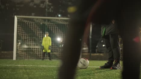 a children's football team trains at the stadium under the guidance of a coach. kids in sports uniforms practice ball exercises, improve technique, and develop teamwork on the green field