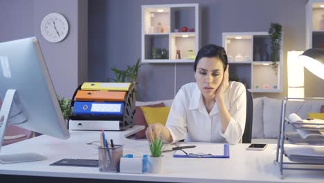 tired young business woman working in her home office.
