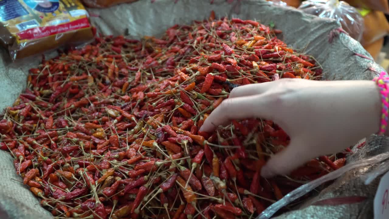 Thai Chili Peppers in Chiang Mai market.  Beautiful red Thai Chili peppers sometimes referred to as Bird's eye chili peppers.  These are spicy, gorgeous and delicious