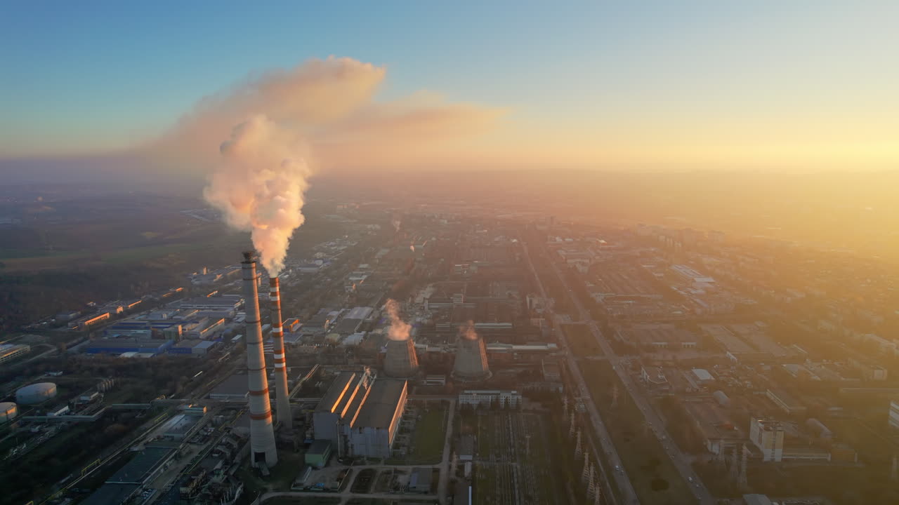Aerial drone view of thermal power plant in Chisinau at sunset, Moldova. View of pipes with felling steam, cityscape