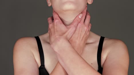 a woman grabs her by the throat because of a piercing sore throat