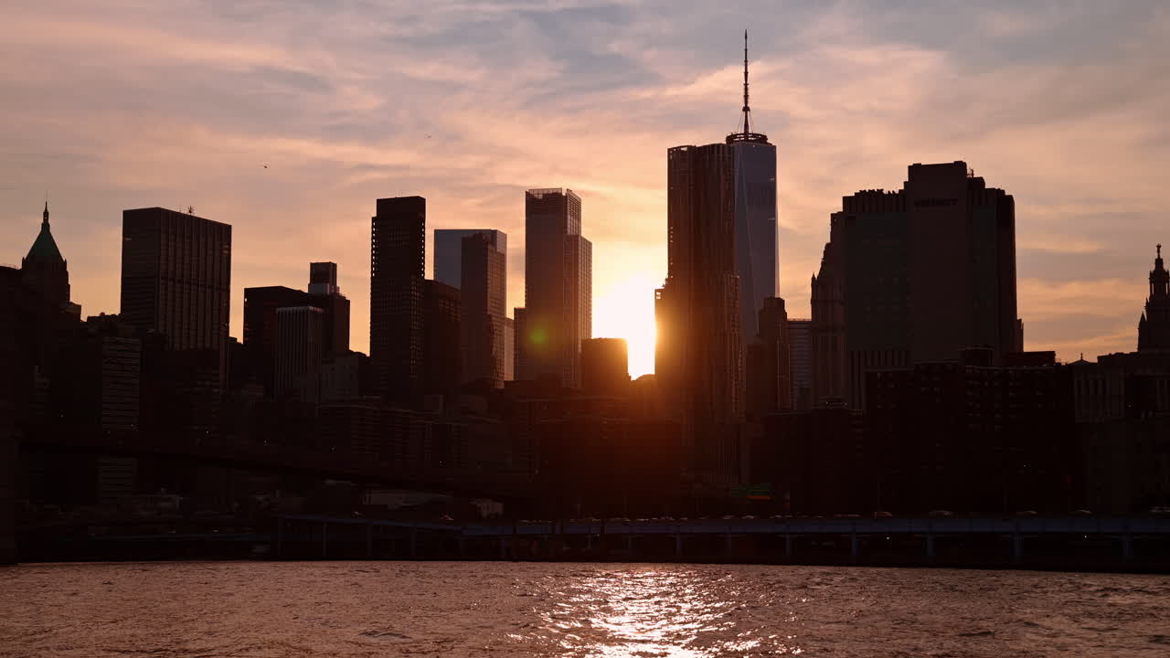 Nueva York, EE. UU., 5 de mayo de 2025: Silueta del horizonte del Bajo Manhattan al atardecer sobre el río. Rascacielos en silueta del Bajo Manhattan, incluido el One World Trade Center, durante la hora dorada al atardecer.