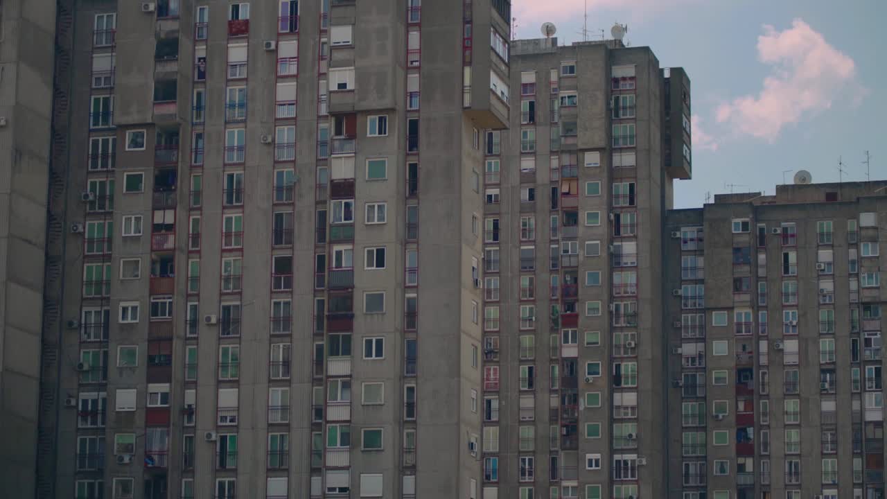 New Belgrade's high-rise residential towers, characterized by varied window styles and balconies. This architectural scene highlights the dense, modernist design in the city's urban landscape.