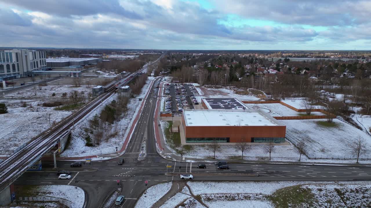 train traveling through a snowy cityscape in segefeld Falkensee. Best aerial view flight drone shot footage from above