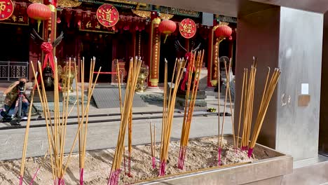 incense sticks burning in a temple setting