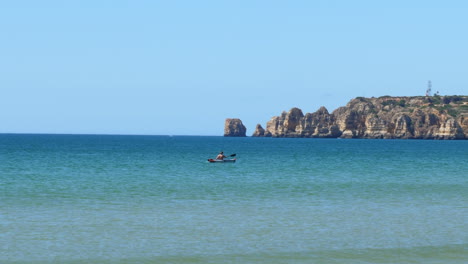 Landscape-with-unrecognizable-person-kayaking-in-sea.-Static