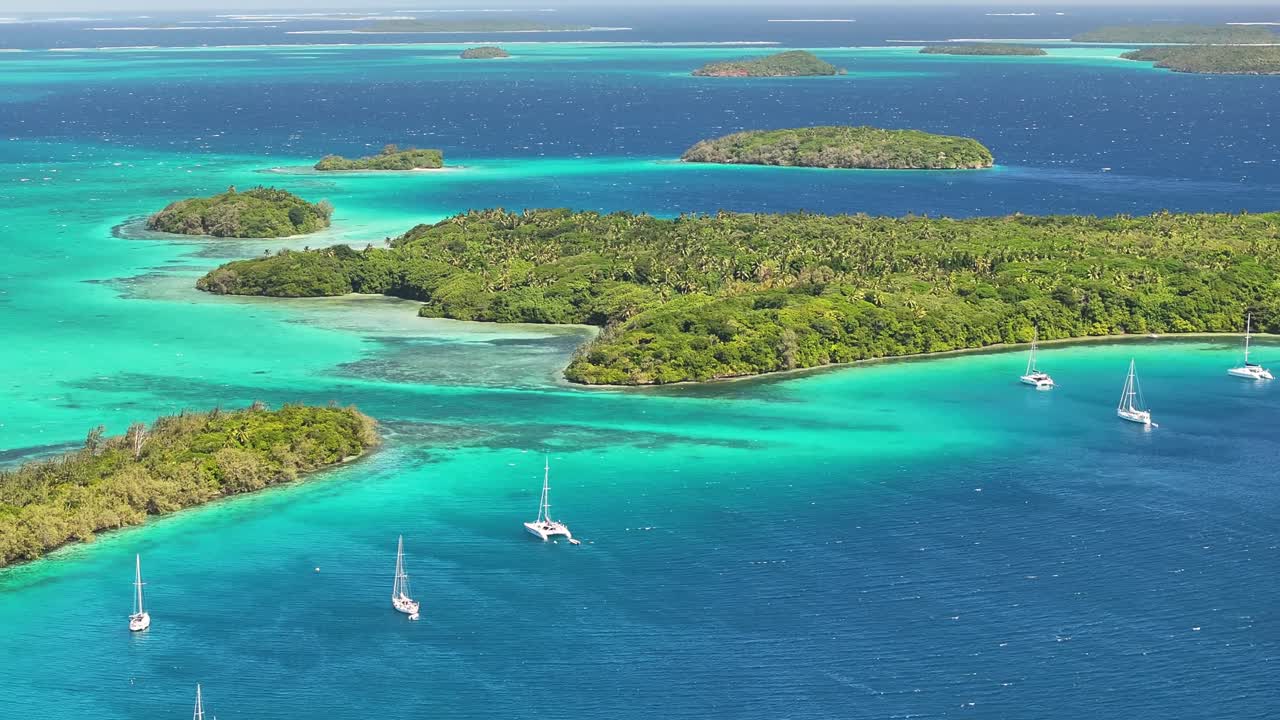 Breathtaking coastal scenery, archipelago Vava'u, Tonga. Boats around green islands and coral reefs.
