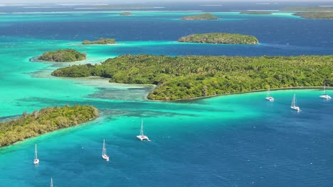 breathtaking coastal scenery, archipelago vava'u, tonga. boats around green islands and coral reefs.