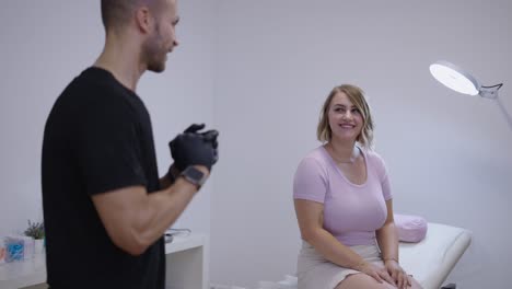 a man in gloves consults with a woman in a clean studio setting