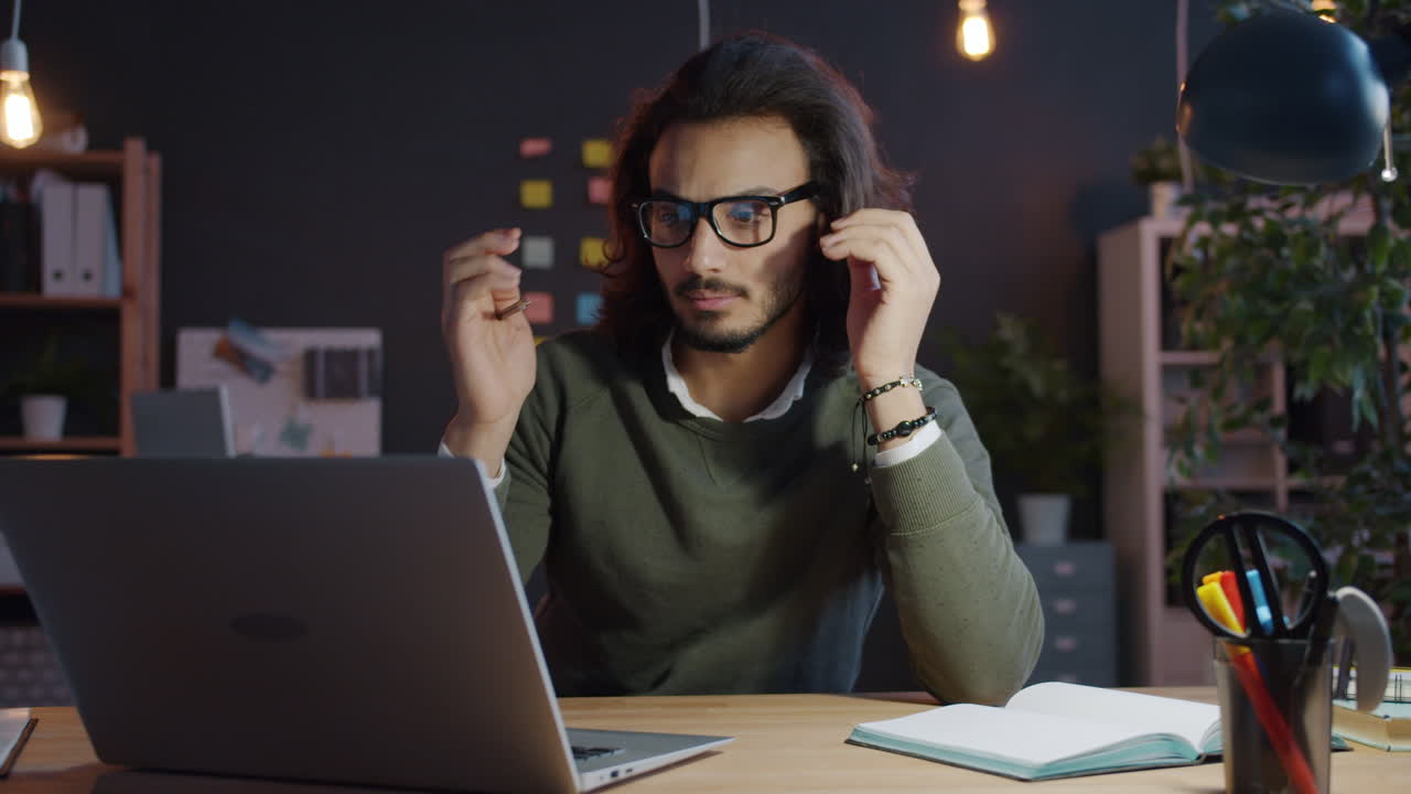 Man Working Late on Laptop in Office