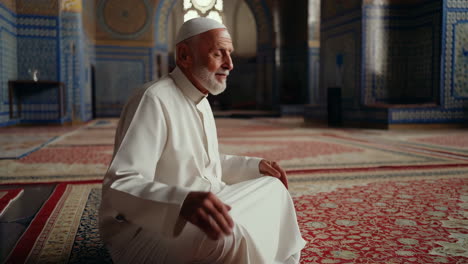 a muslim man praying in a mosque