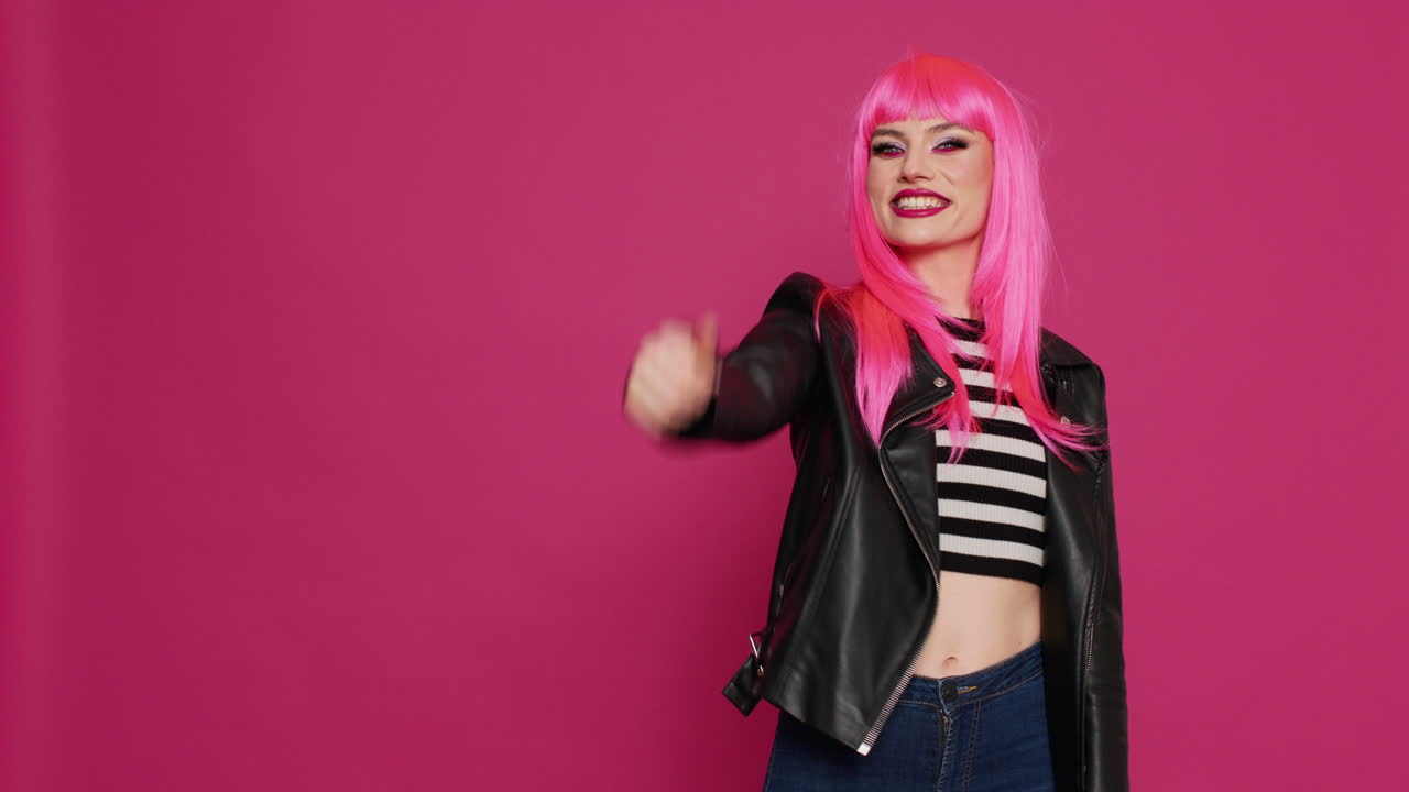 Beautiful trendy model giving thumbs up on camera