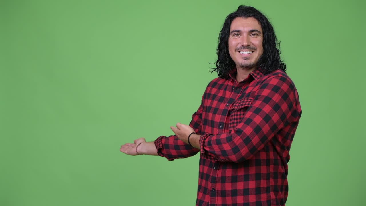 Handsome hipster man showing something