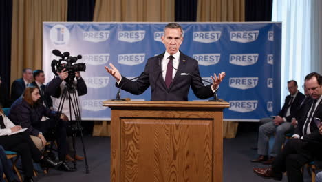 man giving a speech at a press conference