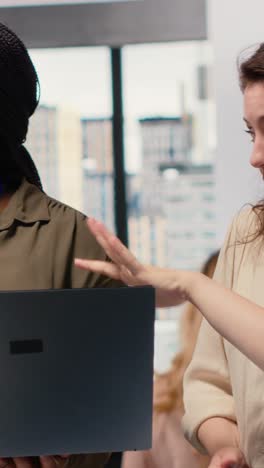 vertical video diverse management staff reviewing advanced ai algorithms and predictive models
