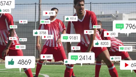 animation of social media icons over team of diverse male soccer players stretching on sports field