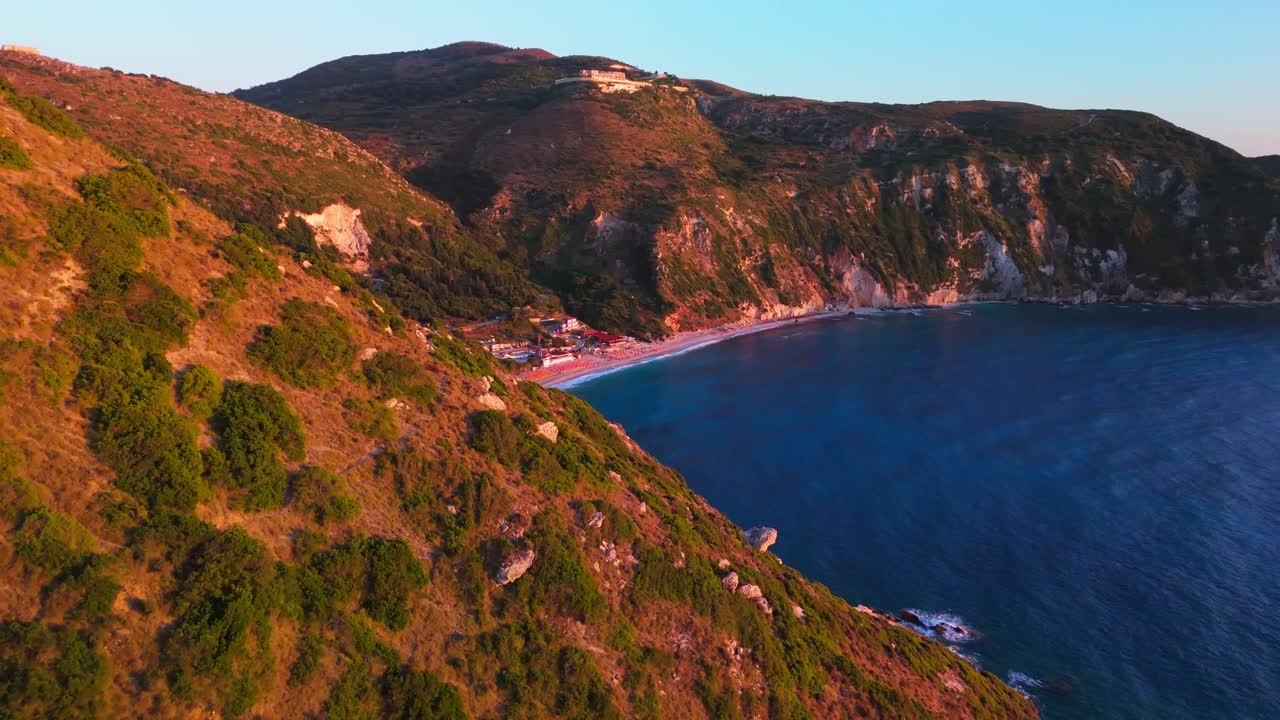 Stunning aerial footage showcasing Petani Beach on the island of Kefalonia, Greece. Captured in 4K, this clip features the turquoise Ionian Sea, dramatic white limestone cliffs, and the golden beach