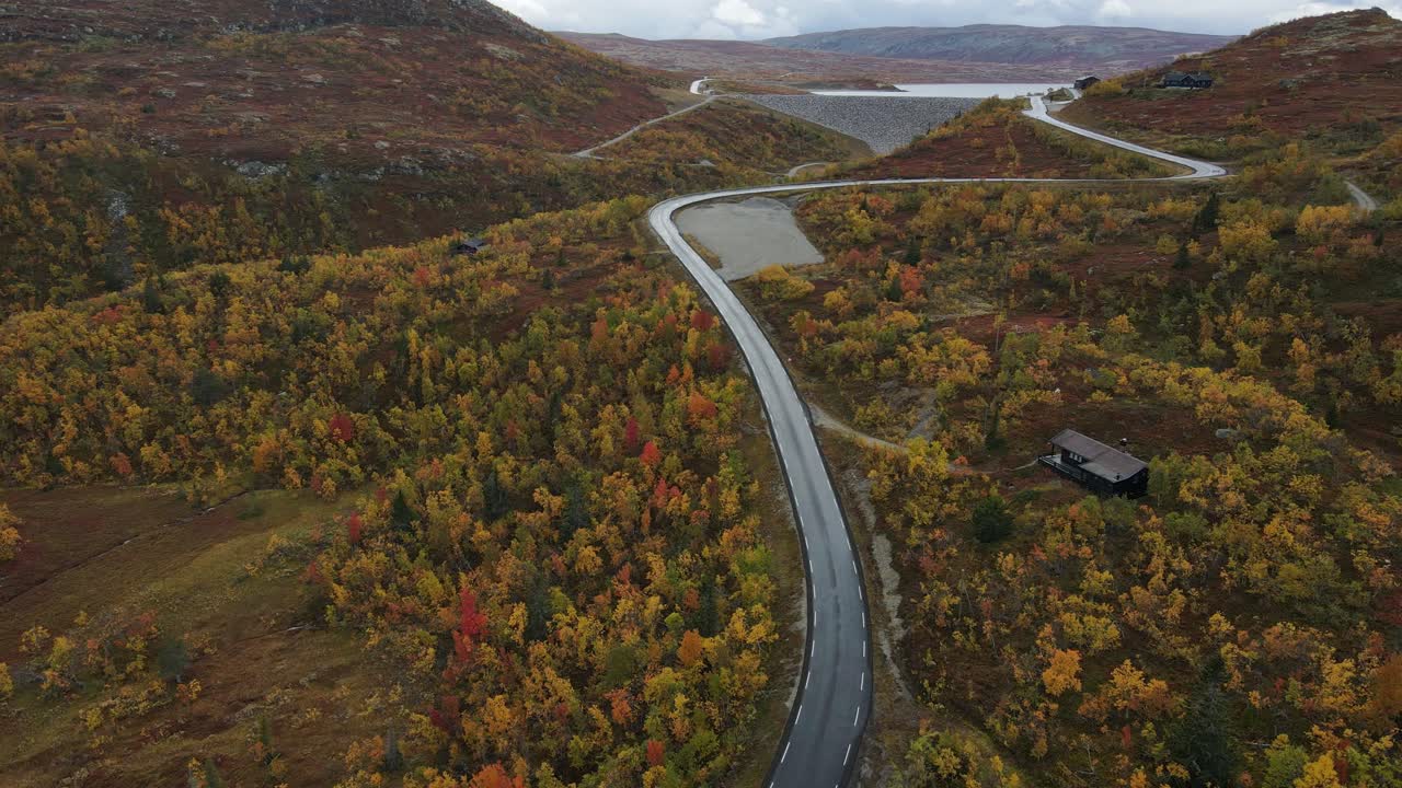 Beautiful curved mountain road an the colorful mountains in Autumn