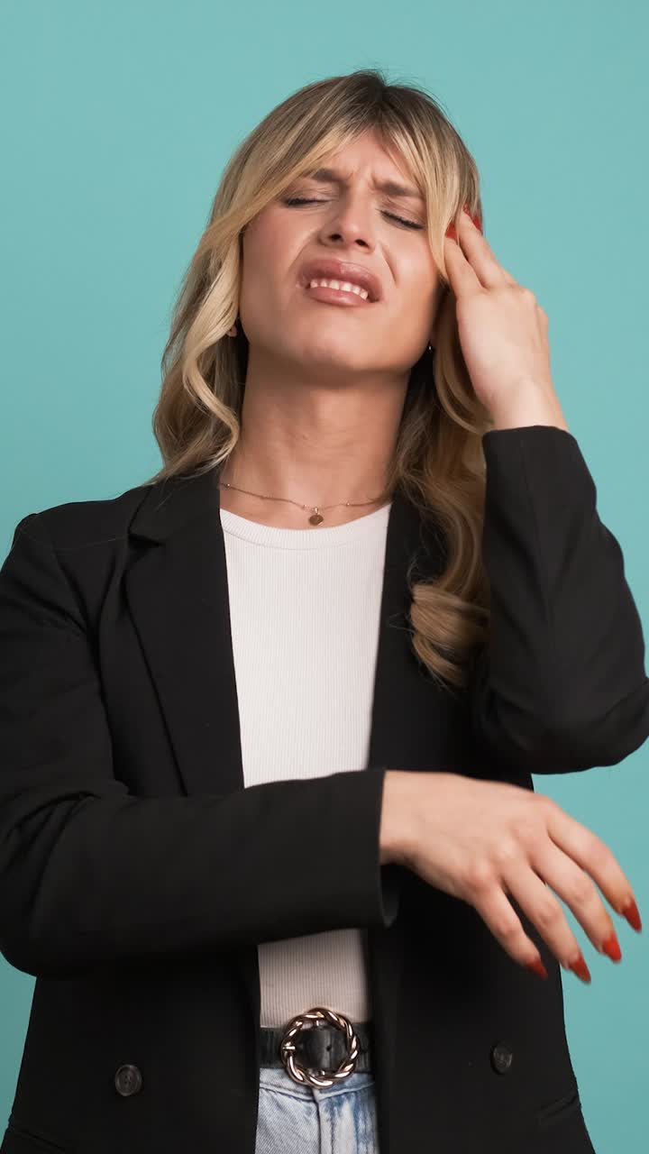 Tired transgender businesswoman suffering from headache