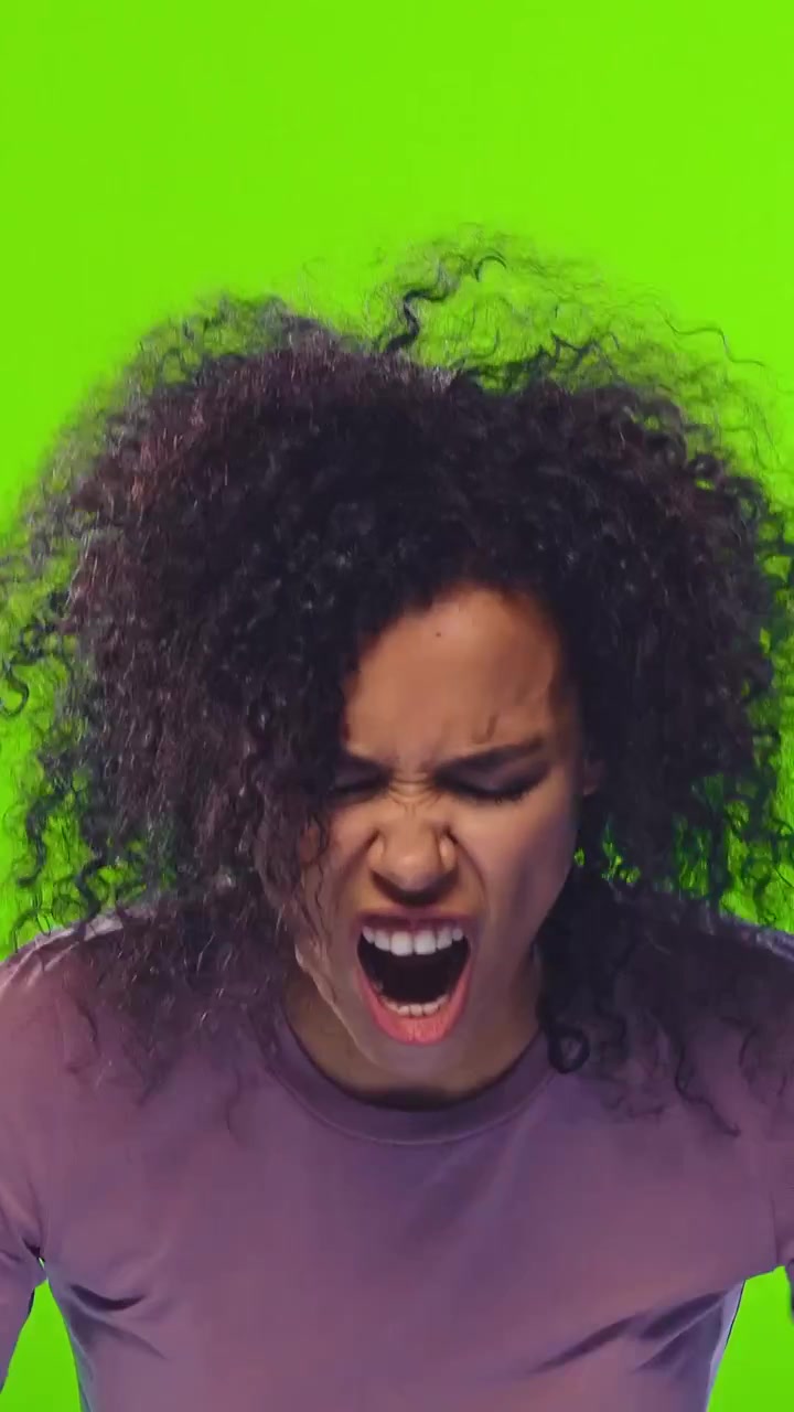 Crying african american woman having a hysterical emotional breakdown on green