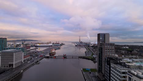 Drone-passing-Capital-Dock,-cloudy-evening-above-Dublin-Docklands