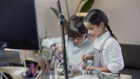 two hispanic children doing school project together