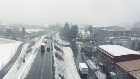 flying-in-an-industrial-area-over-a-busy-street-in-a-snow-blizzard-in-January