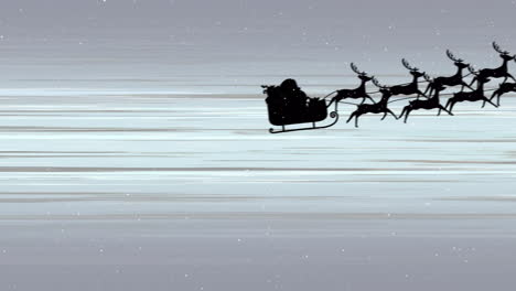 snow falling over silhouette of santa claus in sleigh being pulled by reindeers against light trails