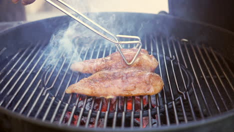 barbecuing perfectly spice-rubbed or marinated chicken breasts on the grill - slow motion