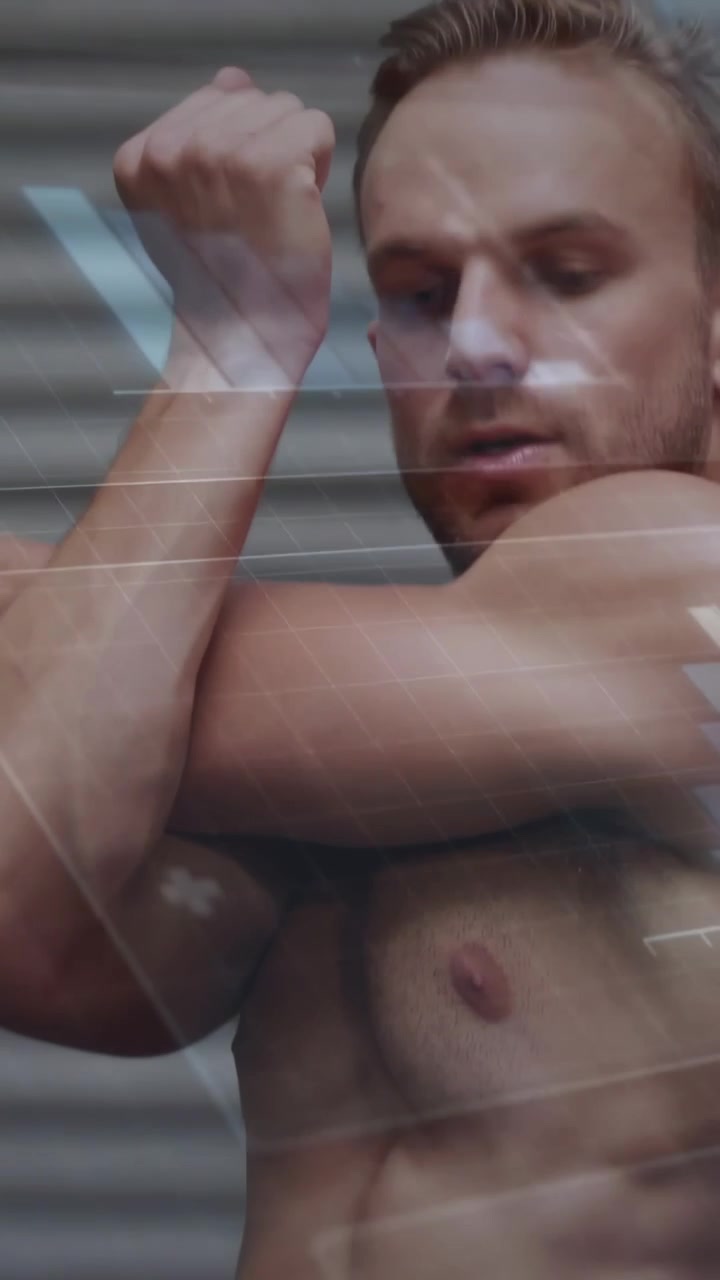 Camera pulling back initiating shirtless man crossing arm rotating lifting overhead showing stretch