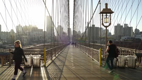 sunrise walk on the brooklyn bridge with manhattan skyline in the background
