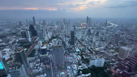 aerial extreme wide bangkok city thailand. chao phraya river winding through skyscrapers twilight. . buildings over financial business district downtown.