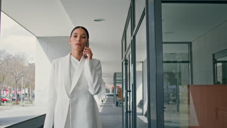 smart lady ceo calling hurrying on office work closeup. woman talking smartphone