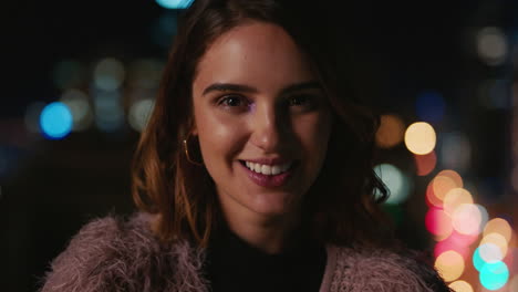 portrait-beautiful-caucasian-woman-on-rooftop-at-night-smiling-happy-enjoying-urban-nightlife-with-bokeh-city-lights-in-background